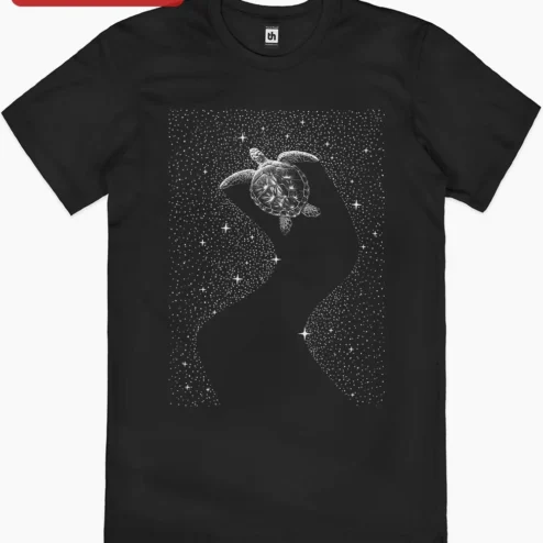 Starry Sea Turtle Graphic Tee Celestial Ocean Life Art Shirt for Women Men on a hanger, ready to ship from Chicago, Illinois