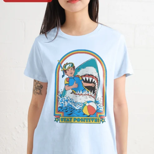 Customer in Chicago, Illinois wearing Stay Positive! Retro Shark Surf Graphic Tee