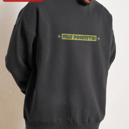 Customer in Chicago, Illinois wearing Stay Positive! Vintage Retro Typography Crewneck Sweatshirt for Men Women Motivational Gift