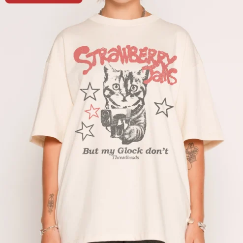 Customer in Chicago, Illinois wearing Strawberry Jams But My Glock Don't Funny Cat Graphic Tee