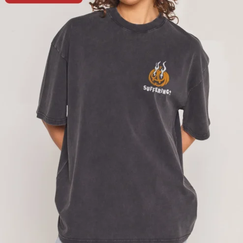 Suffering? Pumpkin Graphic Tee Halloween Acid Wash Shirt on a hanger, ready to ship from Chicago, Illinois