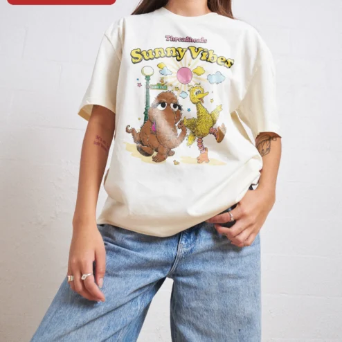 Sunny Vibes Big Bird Snuffleupagus Sesame Street Graphic Tee on a hanger, ready to ship from Chicago, Illinois