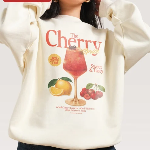 The Cherry Spritz Best Served Cold Sweet Tasty Sweatshirt on a hanger, ready to ship from Chicago, Illinois