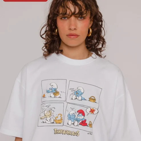 The Smurfs Tee Oversized Vintage Cartoon Graphic T-Shirt Retro Pop Culture Apparel on a hanger, ready to ship from Chicago, Illinois