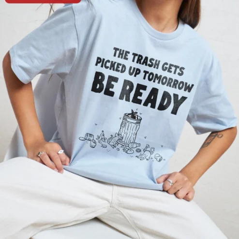The Trash Gets Picked Up Tomorrow Be Ready Tee Funny Garbage Day Humor Shirt for Sanitation Workers on a hanger, ready to ship from Chicago, Illinois