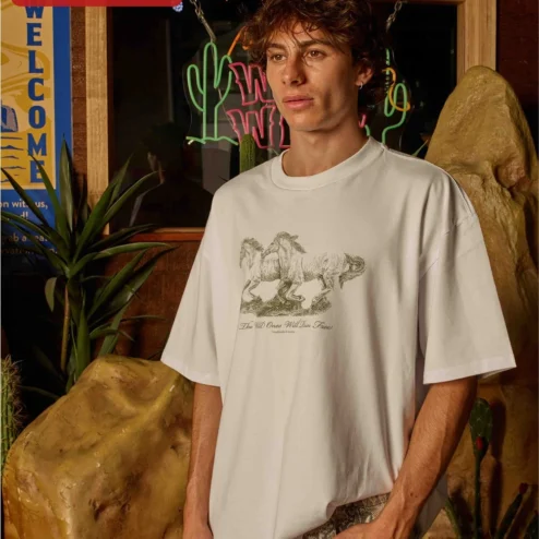 Customer in Chicago, Illinois wearing The Wild Ones Will Run Free Tee Vintage Horse Graphic Shirt for Nature Lovers