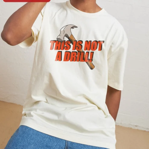 This Is Not A Drill Tee Funny Construction Worker Hammer Graphic Shirt For Men on a hanger, ready to ship from Chicago, Illinois