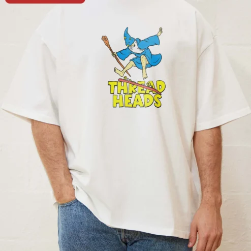Thread Heads Tee Skating Wizard Graphic Shirt Retro Cartoon Streetwear Apparel on a hanger, ready to ship from Chicago, Illinois