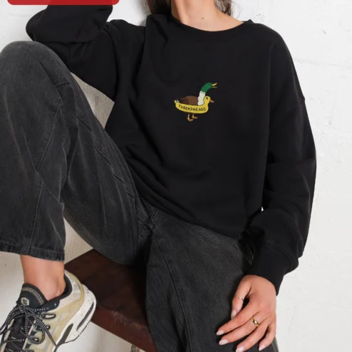 Close-up of THREADHEADS Sweatshirt Black Crewneck Embroidered Two Headed Duck Streetwear Pullover for streetwear fans in Chicago, Illinois