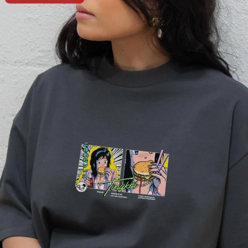 Tinykol First Humanoid Eating a Burger Retro Anime Tee on a hanger, ready to ship from Chicago, Illinois