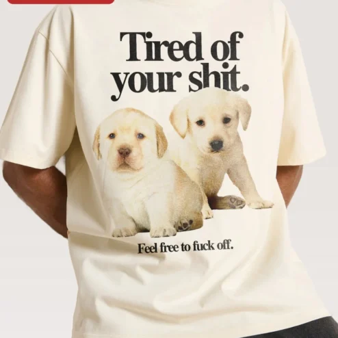 Tired of Your Shit Feel Free to Fuck Off Tee Sarcastic Labrador Puppy Graphic Shirt for Introverts on a hanger, ready to ship from Chicago, Illinois