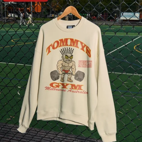 TOMMYS GYM Workout With An Attitude Retro Bodybuilder Crewneck Sweatshirt on a hanger, ready to ship from Chicago, Illinois