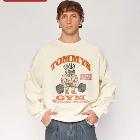 Customer in Chicago, Illinois wearing TOMMYS GYM Workout With An Attitude Retro Bodybuilder Crewneck Sweatshirt