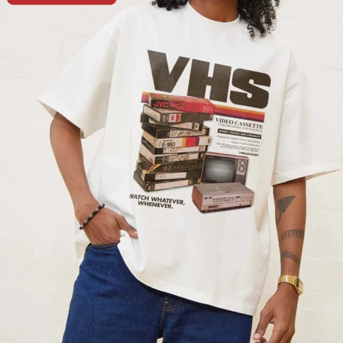 VHS Watch Whatever Whenever Retro Analog Horror Graphic Tee on a hanger, ready to ship from Chicago, Illinois