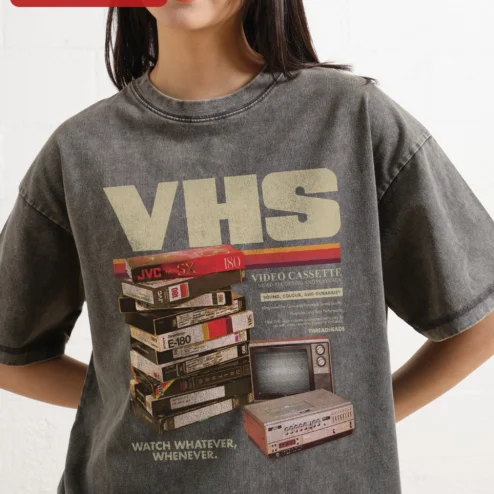VHS Watch Whatever Whenever Retro Tech Nostalgia Graphic Tee on a hanger, ready to ship from Chicago, Illinois