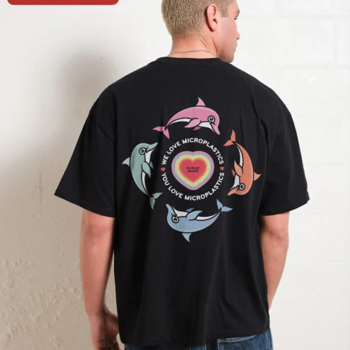 Customer in Chicago, Illinois wearing We Love Microplastics Satirical Eco Awareness Tee Unisex Cotton Graphic Shirt