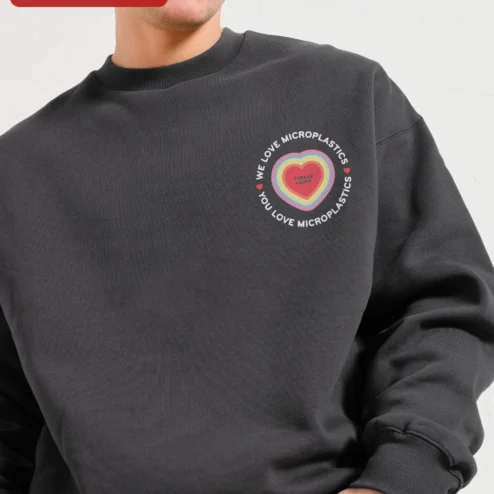 We Love Microplastics You Love Microplastics Funny Meme Sweatshirt Retro Dolphin Graphic Crewneck on a hanger, ready to ship from Chicago, Illinois