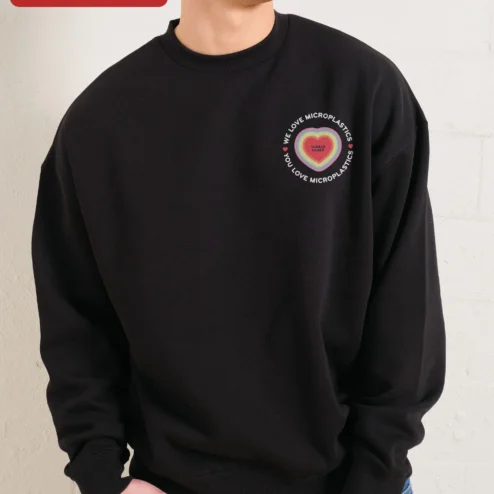 Close-up of We Love Microplastics You Love Microplastics Funny Meme Sweatshirt Retro Dolphin Graphic Crewneck for streetwear fans in Chicago, Illinois