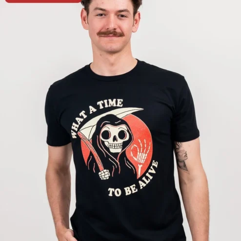 What A Time To Be Alive Grim Reaper Tee Vintage Horror Skeleton Graphic Shirt on a hanger, ready to ship from Chicago, Illinois
