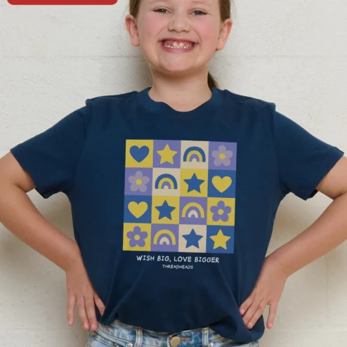 Customer in Chicago, Illinois wearing Wish Big Love Bigger Kids Tee Girls Inspirational Rainbow Heart Star Graphic Shirt