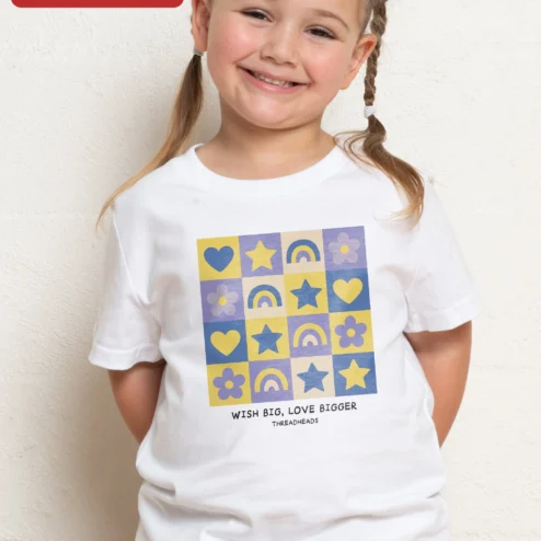 Close-up of Wish Big Love Bigger Kids Tee Girls Inspirational Rainbow Heart Star Graphic Shirt for streetwear fans in Chicago, Illinois
